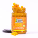 Jar of Spring Veg Piccalilli showing vibrant yellow mustard sauce and crunchy vegetables.